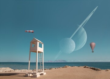 abstract surreal picture with strange building on the sea shore with flying balloon and the planets in the clear sky.