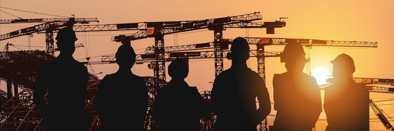 multiexposure construction industrial background of shadow of construction project engineers and workers overlay with silhouette construction project site background