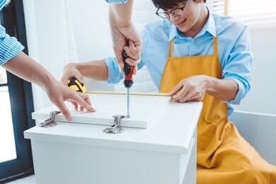 happy asian couple home improvement assembling measuring the furniture moving into new house renovation concept