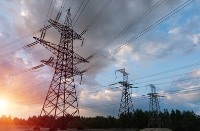 power lines during a beautiful sunset. electricity transportation on beautiful landscapes of the world.