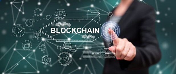 woman touching a blockchain concept on a touch screen with her finger
