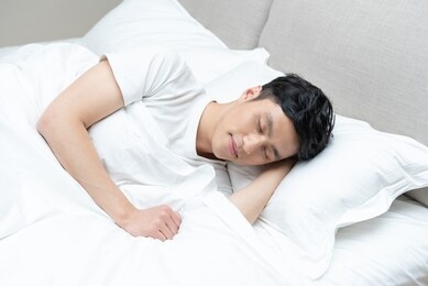 a young asian man is resting