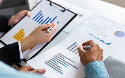 meeting a team of businessmen, executives and accountants meeting about the company's revenue graph in the office with laptops and calculators, finance concept.