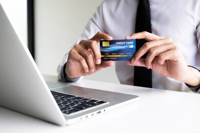 a man holding credit card for shopping online.