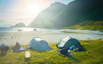 camping in nature outdoor, campsite lifestyle, hot food hiking trip. relax in nature, tourist in camp tent at altantic ocean 
