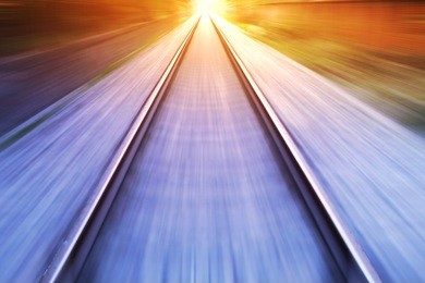 train fast run on railway track in sunny day