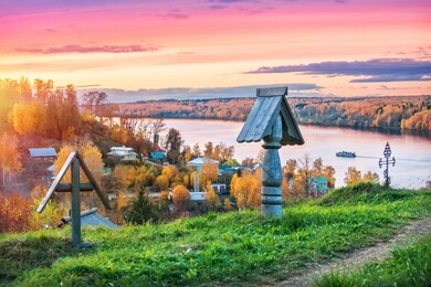 wooden crosses on mount levitan in plyos and a view of the volga against a pink sunset autumn sky