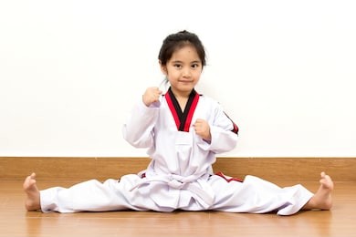 little asian child in fighting action on isolated background