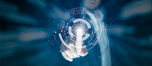 business people are pointing at the technology circle which is like the future there is light on the finger. technology concepts for the future on a black scene.