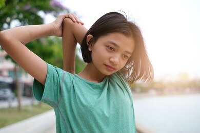 young asian girl exercise at health park.