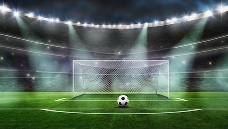 the picture is a composition, not a real stadium------ ball on the green field at soccer stadium. ready for game in fro