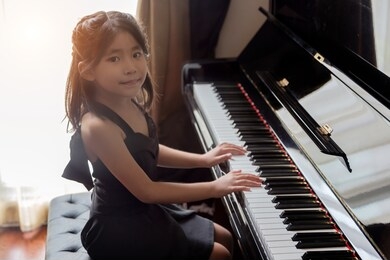 asian girl kids playing piano have talent and practice for up skill of music ability for future occupation.
