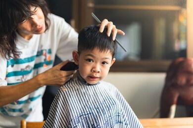 a barber is a person whose occupation is mainly to cut, dress, groom, style and shave men’s and boys' hair. a barber's place of work is known as a barbershop.but this boy has new hair cut at home