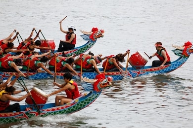 a competitive racing on keelung river, where the women athletes pull vigorously on their oars to the pace of the drumbeats by the team leaders, in the traditional dragon boat festival in taipei taiwan