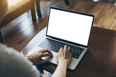 computer mockup image blank screen with white background for advertising,hand woman work using laptop contact business search information on desk at coffee shop.marketing and creative design