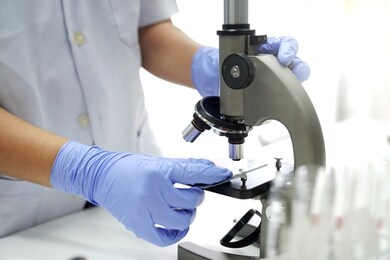 doctors or scientists are using microscopes. to research viruses or chemicals