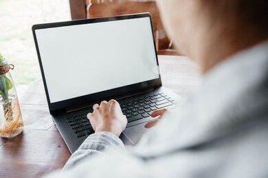 young woman working freelance at computer at home on terrace