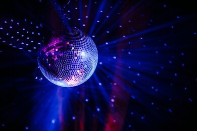disco ball scatters blue light in a dark room