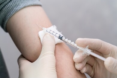 nurse holding a syringe with a vaccine
