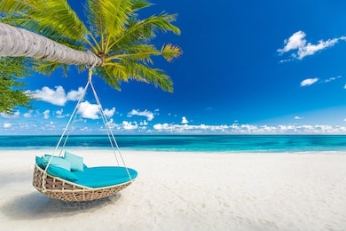 tropical beach paradise as summer landscape with beach swing or hammock and white sand, calm sea for serene beach. luxury beach scene vacation summer holiday. exotic island nature travel destination