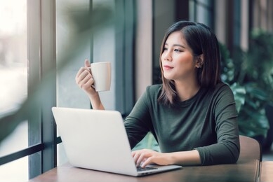 beautiful asian woman using laptop computer online working from home ,  e-learning , online shopping , e-commerce , freelance concept - healthcare and social distancing concept
