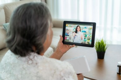 asian senior woman using video conference, make online consultation with pharmacy consulting about illness and medication via video call. telehealth, telemedicine and online hospital.