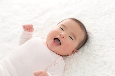 smiling baby lying on the mat