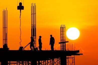 silhouette worker on construction site with sunset sky background in the evening 