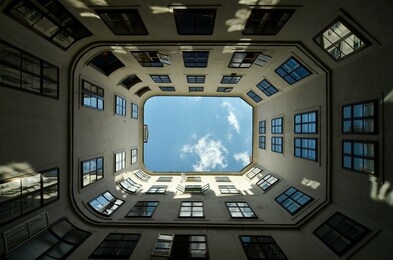 symmetry, abstraction, and abstractionism in architecture. abstract architectural design. an inspiring, artistic image. courtyard-well in the historic district of vienna, bottom view