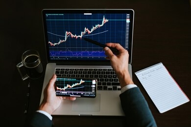 investment stockbroker profit analysis. stock trading graph price prediction and profit gain. trade graph chart. financial manager workplace desk