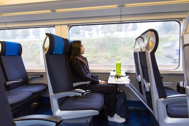 cute young asian female tourists sitting on the express train from narita airport go to downtown tokyo ,japan