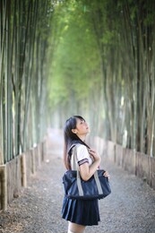 portrait of beautiful asian japanese high school girl uniform looking with bamboo forest background