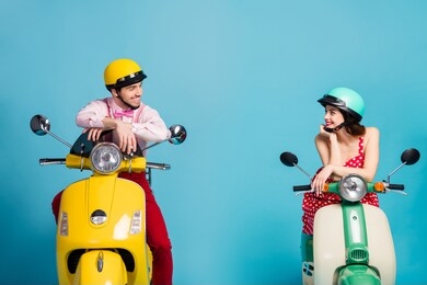 portrait of his he her she nice attractive lovely cheerful cheery couple sitting on moped wearing festal look communicating isolated on bright vivid shine vibrant blue color background