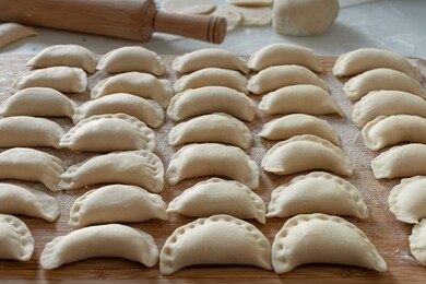 dumplings raw on a wooden board. the process of cooking dumplings. traditional homemade food