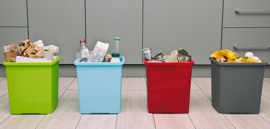 the four different container for sorting garbage. for plastic, paper, metal and organic waste