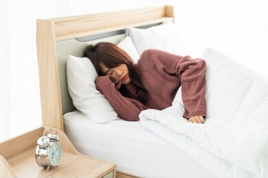 beautiful asian woman sleeping on bed in morning