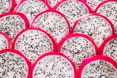 sweet tasty dragon fruit or pitaya slices as a background.