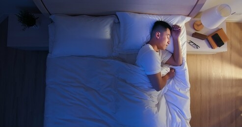 overlooking of asian man sleep well with smile at night 