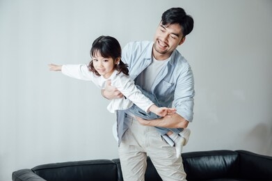 father and daughter at home playing games