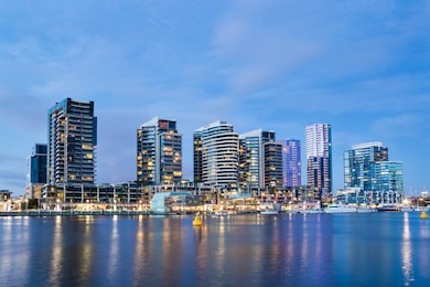 night time image of apartment buildings in the docklands area of melbourne, australia