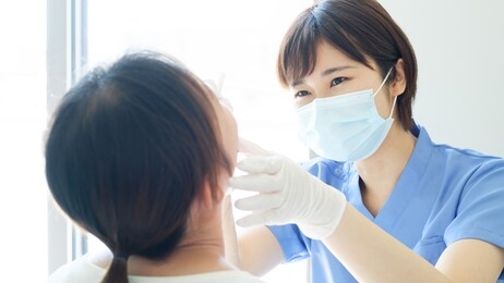 young dentist treating patient teeth at dental hospital