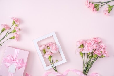 mother's day, valentine's day background design concept, beautiful pink carnation flower bouquet on pastel pink table, top view, flat lay, copy space.