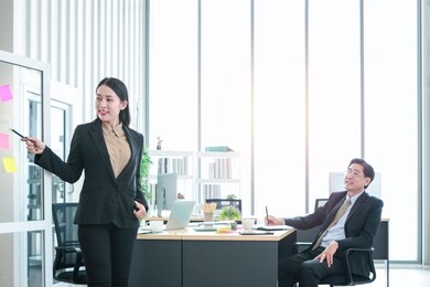 business people meeting, discussing work together in office, senior businessman helping and training new staff at workplace. young businesswoman giving presentation to boss at conference meeting