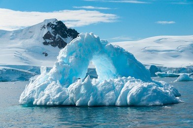 arch shaped iceberg antarctica