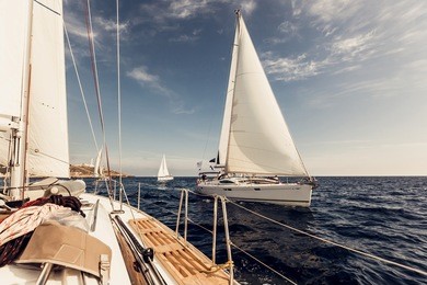 sailing ship yachts with white sails in the open sea