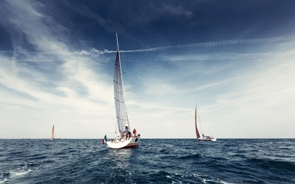 sailing ship yachts with white sails in the open sea