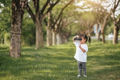 asian girl children using binoculars