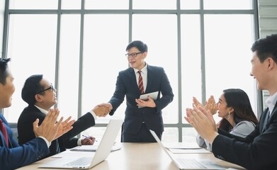 asian business people team shaking hands for dealing sucess. team of businesspeople shaking hands, finishing up meeting in office.