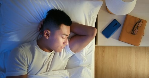overlooking of asian man sleep well with smile at night 