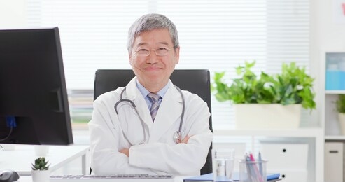 asian senior male doctor smile to you in the clinic